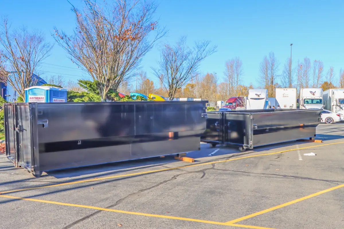 Professional dumpster rental service with roll-off container on residential driveway in Kaysville